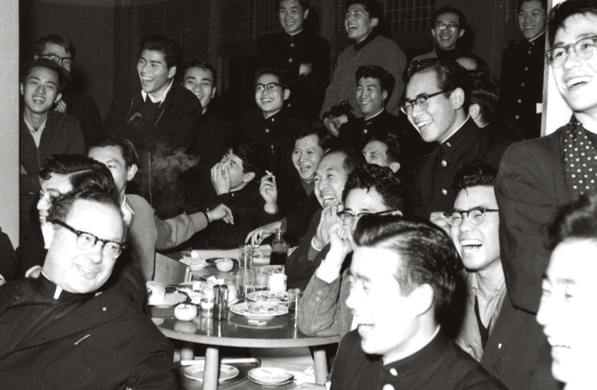 Father Bosch and residents enjoying a Christmas party at the men’s dormitory